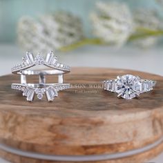 two engagement rings on top of a wooden box