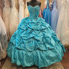 Brand New Aqua Blue Gathered Ball Gown With A Beaded Bodice (With Detachable Rose Accent), Sweetheart Neckline, Corset Back, Large Gathered Skirt (Crinoline Not Included), And Beaded Gathers With Floral Accents. Great For Prom, Homecoming, Wedding, Quinceanera, Quince, Sweet 16, Cosplay, Or Formal Events. Made By Mori Lee, Size 6, Color: Aqua Blue (Very Beautiful Shade, Hints At Turquoise). Moana Quinceanera Dress, Aqua Quinceanera Dresses, Green Ball Dress, Turquoise Quinceanera Dresses, Mori Lee Quinceanera Dresses, Mori Lee Prom Dresses, Corset Ball Gowns, Quinceañera Dresses, Turquoise Ombre