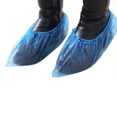 a pair of black boots with blue plastic shoe covers on the soles and ankles