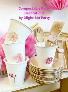 pink and white party supplies with flowers on them