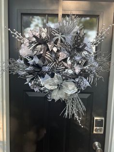 a black and white wreath on the front door