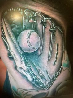 a man with a baseball glove and ball tattoo on his shoulder