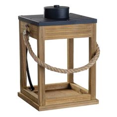 a wooden lantern with rope around it and a black lid on the top, isolated against a white background