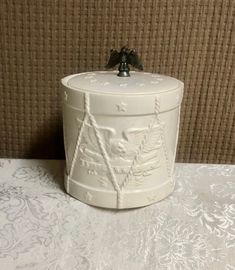 a white ceramic container sitting on top of a table