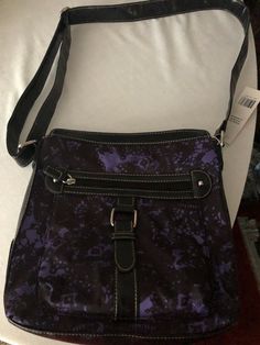 VERY NICE ROSETTI SHOULDER BAG! MADE WITH 100% POLYESTER WITH VINYL TRIM ~ANERICAN FAVORITE HANDBAGS`NICE LONG SHOULD STRAP THAT CAN BE DOUBLE UP. BLACK WITH SPLASHES OF PURPLE, ACTUAL PHOTOS HAVE BENN TAKE! ZIPPER COMPARTMENT I ON THE FRONT, & ON THE BACK & ON THE INSIDE DOWN THE MIDDLE AND ON THE SIDE OF THE BAG! SO YOU WILL HAVE PLENTY OF ROOM FOR ALL YOUR PERSONAL BELONGING! WOW SO PRETTY! Purple Crossbody Bag, Casual Purple Shoulder Bag Satchel, Casual Purple Shoulder Satchel, Casual Purple Satchel With Adjustable Strap, Casual Purple Satchel Shoulder Bag, Trendy Purple Shoulder Bag For Travel, Purple Crossbody Bag With Zipper Closure, Purple Shoulder Bag With Zipper Pocket, Trendy Purple Bag With Zipper Pocket