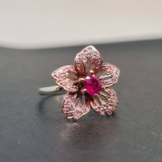 Formal Pink Flower-shaped Rings, Pink Gemstone Flower Ring For Formal Occasions, Formal Pink Gemstone Flower Ring, Formal Pink Flower Shaped Ring, Formal Pink Flower Ring, Flower Shaped Ruby Gemstone Rings, Pink Ruby Ring With Rose Cut Diamonds, Pink Ruby Flower-shaped Jewelry, Flower Shaped Ruby Ring As A Gift