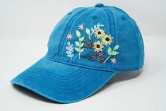 Flower is 100% hand embroidered on a 100% cotton wash black baseball cap. Hat is one size fits all with adjustable back strap. Unique cap, one of a kind! I am also open for customization. If you want the item in different colors, please message me, it will take additional 2-3 days of handling time. Free first class shipping, upgradable priority mail service. 30 days return policy, feel confident at your purchase! Spring Blue Baseball Cap With Embroidered Logo, Blue Visor Baseball Cap For Spring, Blue Hats With Embroidered Logo For Spring, Spring Blue Hats With Embroidered Logo, Blue Spring Hats With Embroidered Logo, Blue Curved Bill Trucker Hat For Spring, Spring Blue Dad Hat With Curved Bill, Blue Trucker Hat With Curved Bill For Spring, Blue Embroidered Visor Baseball Cap