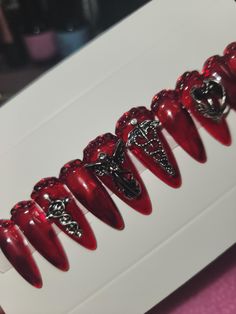 Goth style blood jelly medium almond press on nails. Red rhinestone cuticle area, and gothic silver Charm accent nails. Black jelly blooming gel effect. size s/m Red Nails Charms, Red Nails With Charms, Press On Nails Red, Blood Nails, Blooming Gel, Almond Press On Nails, Medium Almond, Nails Red, Goth Style