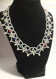 A handmade glass beaded necklace that is perfect for any occasion: parties, holidays, birthdays, anniversaries. All products are hand-crafted by my mother. Dimensions: - Actual Length: 23.0 cm - Collar Length: 13.0 cm - Width: 16.0 cm - Height: 2.0 cm Lightweight, high quality with a beaded hook as a clasp. Will respond to concerns and suggestions promptly. Acrylic Pearls: 8 mm. Shipping costs: Free Domestic Shipping. All orders are sent by air-mail with tracking number. Time of delivery: Estima Artisan White Beaded Chain, Handmade Beaded Necklaces With Round Beads For Celebration, Beaded Czech Glass Round Beads, Handmade Beaded Bracelets With Round Beads For Celebration, White Artisan Beaded Necklaces With Beaded Chain, White Artisan Beaded Necklace With Beaded Chain, Artisan White Beaded Chain Necklace, White Glass Jewelry With Large Beads, Beaded Czech Glass For Jewelry Making