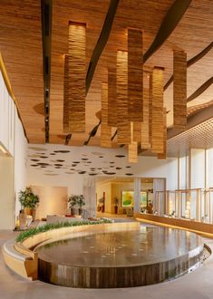 the inside of a large building with lots of windows and wooden ceiling lights hanging from it's rafters