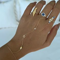 14K Gold Diamond Hamsa Evil Eye & Star of David Hand Chain on woman's hand with multiple rings, luxury and spiritual jewelry. Body Jewelry Men, Hamsa Evil Eye, Stacked Necklaces, Blue Accessories, Popular Jewelry, Initial Jewelry, Hand Chain, Star Of David, Bezel Diamond