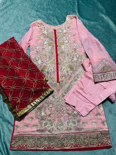 size:Medium  Heavy embroidered Stitched 3piece dress. Shirt: front heavy embroidered and embroidered on back & design on sleeves and shirt bottom. Dupatta: heavy embroidery on chiffon  bottom:straight plain pant No return or exchange please. Note:Please contact me if you have any problem with your order. Pink Chanderi Dress With Intricate Embroidery, Semi-stitched Saree Dress With Intricate Embroidery, Pink Dola Silk Dress With Dabka Work, Semi-stitched Straight Kurta Dress With Resham Embroidery, Fitted Party Wear Embroidered Fabric For Festivals, Fitted Embroidered Party Wear Fabric For Festivals, Embroidered Anarkali Georgette Dress, Party Wear Georgette Sharara With Floral Embroidery, Festive Party Wear Kurta With Intricate Embroidery