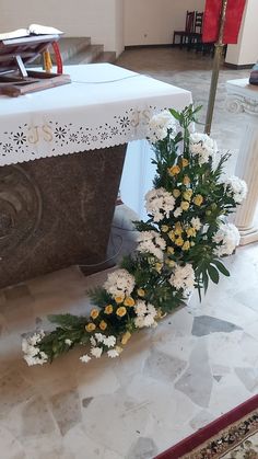 flowers are laying on the ground in front of a church alter