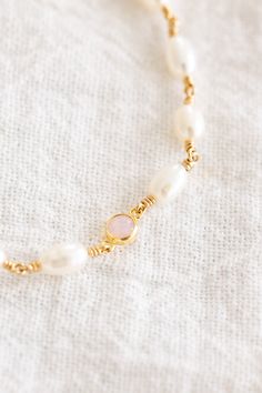 14k gold filled bracelet with 5mm - 7mm freshwater pearls wire wrapped individually with a 4mm pink opal charm Comes with an attached 1" extender chain + 3mm freshwater pearl at the end! If you would like a different length that is not listed, please contact us for a custom order! Finding Your Size We recommend using a flexible measuring tape to wrap around your wrist to find the length of your preferred fit. An alternative to this is getting a piece of string or shoelace, wrap that around your wrist, and measure the length in inches Bar Jewelry, Jewelry Workshop, Anklet Bracelet, Measuring Tape, Stamped Jewelry, Pink Stone, Pink Opal, Birthstone Necklace, Stone Bracelet