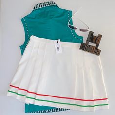 Nwt. Prince Solid & Striped Gia White With Red & Kelly Green Trim Pleated Skirt. Rather You Play Tennis Or Pickleball, You Will Look Absolutely Fabulous In The Crisp White Skirt With Flirty Pleats & Trim! White With Red 1/4” Grosgrain Trim & Green 1/4” Grosgrain Trim 6 - Pleats On Front (3 On Either Side) & 6 - Pleats On Rear (3 On Either Side) Single Button(Extra Button Included)/Zipper Closure On Left Side 78% Polyester/19% Rayon/ 3% Spandex Waist (Measured Side To Side): 17” Length: 16” Pet F Retro Red Skort For Summer, Retro Red Summer Skort, Retro White Skirt For Summer, White Retro Skort For Summer, Retro White Skort For Summer, White Retro Skort For Spring, White Retro Style Skort For Spring, Preppy Green Skort For Summer, Retro White Skirt For Spring