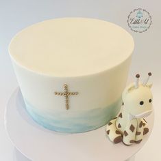 a cake with a giraffe figurine next to it on a plate