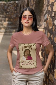 "Introducing our \"Brown Baddie\" Graphic T-shirt - a stunning fusion of South Asian culture and boho artistic flair that celebrates the strength and beauty of South Asian women. Pair it with your favorite jeans, skirts, or shorts for a casual day out, or dress it up with accessories for a chic boho-inspired ensemble. This tee effortlessly transitions from everyday wear to a fashion statement. Searching for the perfect gift for a South Asian friend or loved one? Look no further! This \"Brown Bad Brown Bohemian Crew Neck T-shirt, Bohemian Brown Crew Neck T-shirt, Brown Cotton T-shirt, Brown Baddie, South Asian Culture, South Asian Women, Fashion Illustrations Techniques, Asian Culture, South Asian