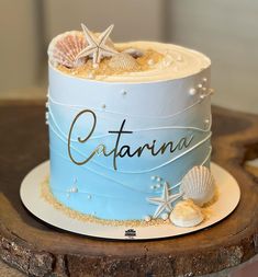 there is a cake that has been decorated with seashells and starfish on it