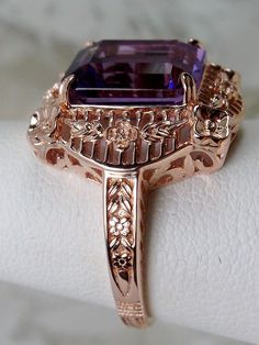 Natural Purple Amethyst Rose Gold plated Sterling Silver RingPicture Frame Design#D227 Inspired by Victorian era designs, this is a lovely reproduction ring. This lovely filigree handcrafted sterling silver ring is overlaid with rose gold plating. This flawless 5 carat Natural Purple Amethyst is 11mm x 9mm. The ring is 11/16" (17.5mm) North to South on the finger. The inside of the band is marked 925 for sterling silver. Notice the beautiful daisies on the outside of the setting and band. There Fine Jewelry In Rose Gold With Intricate Design, Intricate Rose Gold Sterling Silver Jewelry, Rose Gold Fine Jewelry With Intricate Design, Ornate Rose Gold Jewelry With Intricate Design, Ornate Rose Gold Filigree Jewelry, Luxury Rose Gold Amethyst Ring For Anniversary, Elegant Purple Amethyst Ring With Filigree, Elegant Purple Amethyst Filigree Ring, Rose Gold Filigree Jewelry For Anniversary