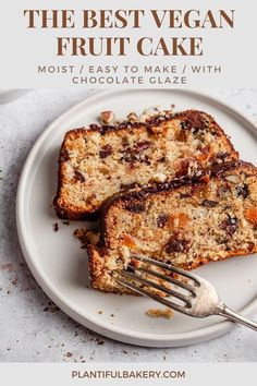 the best vegan fruit cake with chocolate glaze is on a white plate and has a fork in it