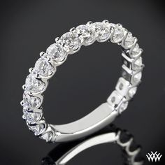 a white gold ring with five stones on the inside and outside, set in 18k white gold