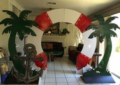 a living room decorated with palm trees and life preservers in front of a mirror