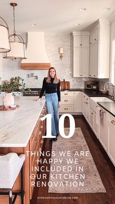 a woman standing in the middle of a kitchen