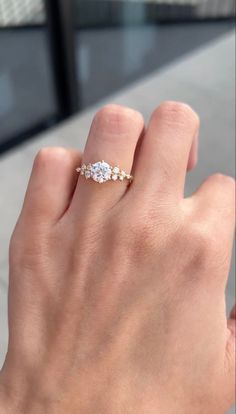 a woman's hand with a diamond ring on it