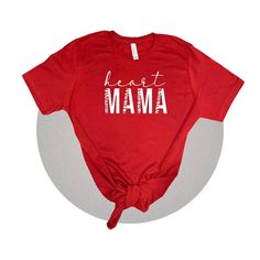 "This super cute new design is personalized and a perfect tee for any new heart mama out there. I wanted to create something minimalist but also stylish. My inspiration is certainly CHD Awareness but wanted to have fun with the graphic! I also wanted to get some red shirt designs out there with Heart Month quickly approaching us. This shirt is rocking the words \"Heart Mama\" in a stylish font.  Simple yet nice. It is a Unisex Jersey Bella Canvas 3001C that is 100% ringspun cotton and super comf Mother's Day Short Sleeve T-shirt With Heart Print, Red T-shirt For Valentine's Day Gift, Mother's Day Heart-shaped T-shirt With Letter Print, Red Short Sleeve T-shirt For Gift, Short Sleeve T-shirt With Heart Print For Mother's Day, Mother's Day Heart Print Short Sleeve T-shirt, Red Custom Print Top For Gift, Red Custom Print Top As Gift, Mother's Day Crew Neck Top With Heart Graphic