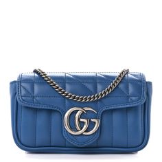 This is an authentic GUCCI Calfskin Matelasse Aria Super Mini GG Marmont Shoulder Bag in Clear Blue.This shoulder bagis crafted of smooth and supple blue calfskin leather with geometric quilting. It features a removable aged silver chain strap and a prominent GG logo on the front. The crossover flapopens to a beige microfiber interior. Gucci Soft Leather Rectangular Shoulder Bag, Classic Blue Gucci Shoulder Bag, Gucci Soft Leather Crossbody Bag, Classic Gucci Soft Leather Bag, Gucci Soft Leather Travel Bag, Gucci Soft Leather Crossbody Shoulder Bag, Designer Gucci Bag In Soft Leather, Designer Gucci Soft Leather Bag, Blue Gucci Shoulder Bag