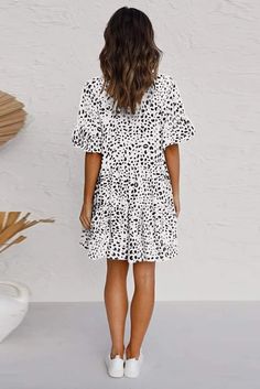 White Leopard V Neck Ruffled Mini Dress with Buttons White V-neck Tiered Casual Dress, Casual Ruffle Dress With Ruffle Hem And Sleeves, Casual Flowy Ruffle Dress With Short Sleeves, Casual Mini Dress With Ruffle Hem And Flutter Sleeves, Casual Vacation Tiered Dress With Ruffle Hem, Casual Ruffle Dress With Flutter Sleeves For Day Out, Casual Tiered Dress With Ruffle Hem For Vacation, Casual Midi Dress With Ruffle Sleeves For Vacation, White Casual Mini Dress With Ruffle Sleeves