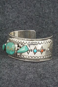 This stunning and substantial turquoise, coral and sterling silver bracelet was made by Navajo silversmith Emerson Delgarito. The inside is signed E. Delgarito and stamped sterling.Size: 5 3/8" (will fit up to a 6 1/2" wrist)Gap: 1 1/8"Length: 1 1/8"Free shipping on all orders! We ship with USPS and always include tracking. All orders ship within a day of payment.Returns are accepted up to 30 days after you receive your order. Just send us a message. Our shop offers cash back or store credit. Th Southwestern Silver Multi-stone Bracelet, Southwestern Silver Bracelet With Multi-stone, Southwestern Silver Multi-stone Bracelets, Southwestern Turquoise Multi-stone Bracelets, Unique Turquoise Sterling Silver Bracelet Collectible, Southwestern Sterling Silver Inlay Bracelet Gift, Coral Turquoise, Silver Turquoise, Native American Jewelry