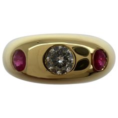 Vintage Cartier Diamond & Ruby 18k Yellow Gold Three Stone Daphne Ring. Stunning yellow gold Cartier ring set with a beautiful 3.5mm centre diamond with F/G Colour and VVS clarity. This is accented by 2 fine deep red rubies approx 2.5mm each. Fine jewellery houses like Cartier only use the finest of gemstones in their jewellery. The ring is signed Cartier 750 with serial numbers and a French eagle hallmark. Ring size UK L1 - US 6 - EU 51 - Resizing is possible. Well made heavy ring weighing 7.3g. The ring has been professionally polished and cleaned, in excellent condition with only some light signs of wear. Comes with Cartier ring box. Gold Cartier Ring, Birmingham Jewellery Quarter, Cartier Diamond, Domed Ring, Three Stone Rings, Cartier Ring, Selling Jewelry, Three Stone, Deep Red