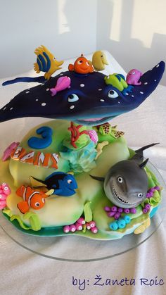 two cakes decorated to look like animals and fish