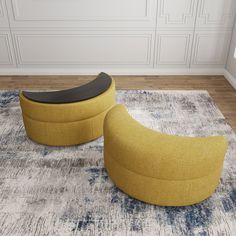 two yellow chairs sitting on top of a rug in a room with white walls and wooden floors