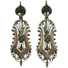 Elaborate filigreed Victorian 14k gold earrings from the late 19th Century. Rose gold applications in harp form are framed by etruscan bead work and florets. Yellow gold has been left with original patina. Can be polished to high finish if needed. 1880's USA. Excellent condition. 1 5/8" x .5".