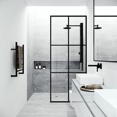 a white bathroom with two sinks and mirrors on the wall next to it's glass doors