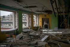 an abandoned building with broken windows and debris