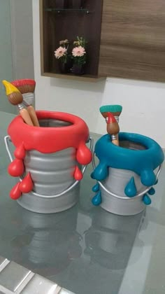 two buckets that have toothbrushes in them