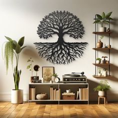 a living room with a record player, potted plants and a metal tree wall hanging on the wall