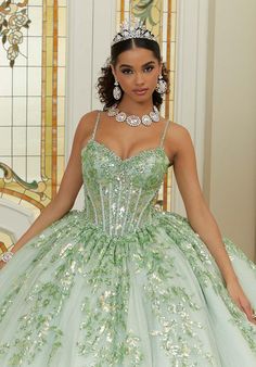 a woman wearing a green dress and tiara