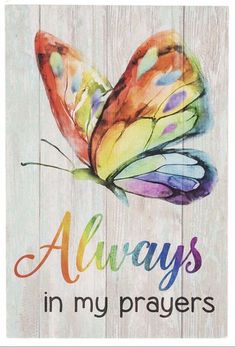 a wooden sign that says always in my prayer with a butterfly painted on it's wings