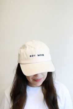 Being a Boy Mom becomes your identity, so we made a hat that celebrates it! The unisex fit is embroidered with Boy Mom on the front and has an adjustable strap in the back. Here are the details: - Adjustable strap designed to fit most - made of a soft, flexible cotton twill - Color: White, navy thread- design is exclusive to polished prints Trendy Adjustable Curved Visor Hat, Adjustable Fitted Cap With Letter Print, Adjustable Cotton Fitted Hat, Adjustable Cotton Trucker Hat With Embroidered Logo, Adjustable Trucker Hat With Embroidered Logo And Visor, Everyday Snapback Baseball Cap With Embroidered Logo, Adjustable Cotton Hat With Embroidered Logo, Embroidered Logo Snapback Baseball Cap, Adjustable Visor Hat With Letter Print