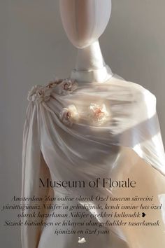 an advertisement for the museum of flotale featuring a mannequin wearing a white dress with flowers on it