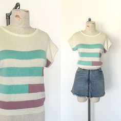 - Vintage 1980's era short sleeve striped sweater top - No fabric label, feels like a medium weight acrylic (or blend) ribbed sweater knit - Light cream color with striped design on front in turquoise and mauve - Wide rounded neckline and short cap sleeves - Ribbed knit waistband - Back side is solid cream *Skirt in photo not included. SIZE: no size label, Fits like a Small LABEL: Sweet Apple MEASUREMENTS: Chest 38", Waist 26" (+ some stretch), Shoulder to waist 21" CONDITION: Overall great condition. No visible marks or flaws to note. *See the rest of my shop here: valleygirlphx.etsy.com Retro Striped Ribbed Tops, Retro Striped Short Sleeve Shirt, Retro Striped V-neck Top, 90s Striped Short Sleeve T-shirt, Blue Short Sleeve T-shirt With Contrast Stripes, Cream Skirt, Vintage Preppy, Fabric Labels, Pullover Sweater Women