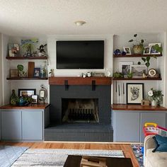 a living room filled with furniture and a flat screen tv mounted on the wall above a fire place