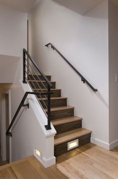 the stairs in this house have been built to match the wood and metal railings