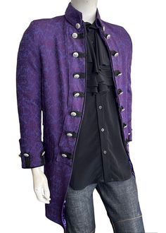 This 1775 British Army-inspired jacket is a classic Couture piece featuring distinctive contrast details reminiscent of the coats of the British Army. The modern design is expertly tailored in a purple brocade pattern and embellished with fleur de lis embossed metal buttons to give a timeless look. Elevate your outfit with this rockstar-style jacket.     Self: Cotton/Poly, Lining: Polyester     3/4 Length     Dry Clean Only     Made in USA Historical Long Sleeve Outerwear For Fall, Historical Design Long Sleeve Outerwear For Fall, Fitted Historical Outerwear For Fall, Buttoned Outerwear For Halloween Costume Party, Purple Long Coat For Formal Occasions, Formal Purple Long Coat, Victorian Style Long Sleeve Outerwear For Costume Party, Fitted Historical Design Outerwear With Long Sleeves, Victorian Outerwear For Costume Party In Fall