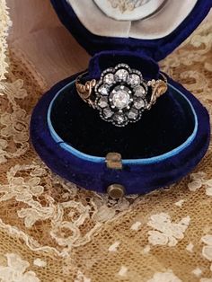 This listing is for an antique Georgian Period Rose cut diamond cluster ring set in sterling silver and 18K gold. The top of this ring is of the period and has been authenticated as such, but the shank has been replaced at some point during her very long life. This is very typical of Georgian pieces. There are solder marks and several hallmarks on the shank. These hallmarks pertain to the shank only. The ring is a size 8.25 U. S . The shank dates to the 1920's. It does test as 18 k and the ring Antique Cluster Ring With Rose Cut Diamonds, Victorian Diamond White Ring With 17 Jewels, Victorian Style Diamond Cluster Ring, Victorian Cluster Ring With Brilliant Cut In Diamond White, Formal Flower Ring With Single Cut Diamonds, Vintage Rose Cut Diamond Promise Ring, Victorian Cluster Ring With Diamond Accents, Antique Cluster Diamond Ring With Center Stone, Victorian Diamond Cluster Ring