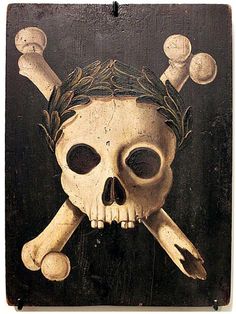 a skull and crossbones painted on a wooden plaque